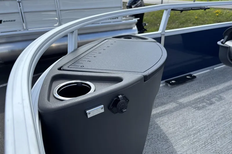 Slide: The Image of 2026 Sun Tracker Bass Buggy 18 DLX boat console with cup holder and measurement markings. - 4