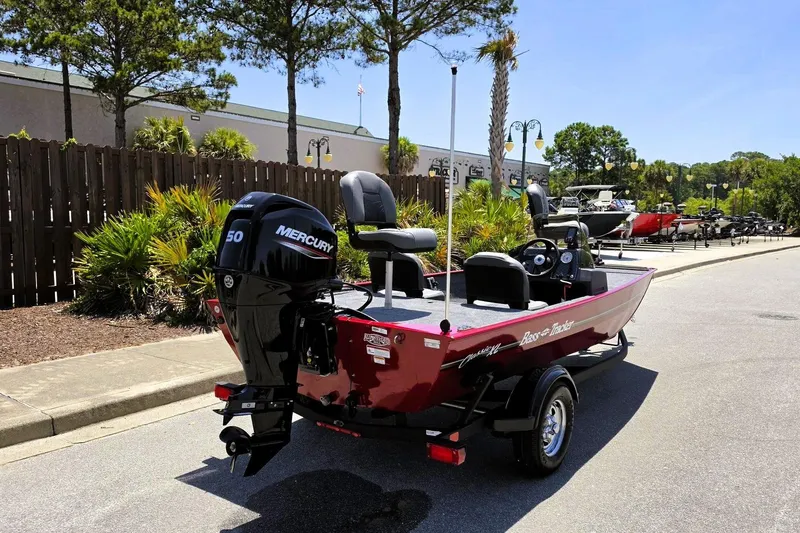 Slide: The Image of 2026 Tracker Bass Tracker Classic XL boat with Mercury engine, parked outdoors. - 3