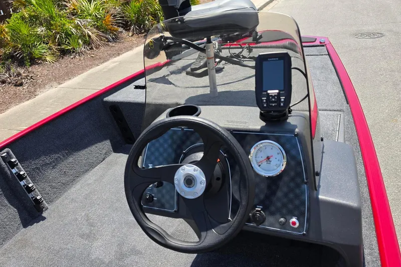Slide: The Image of 2026 Tracker Bass Tracker Classic XL boat dashboard with steering wheel and navigation system. - 12