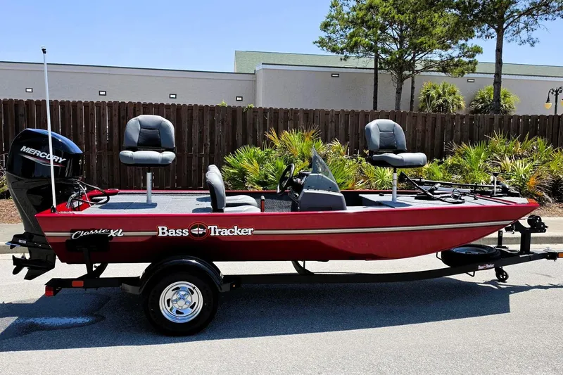 The Image of 2026 Tracker Bass Tracker Classic XL boat with Mercury engine, parked outdoors. - 0