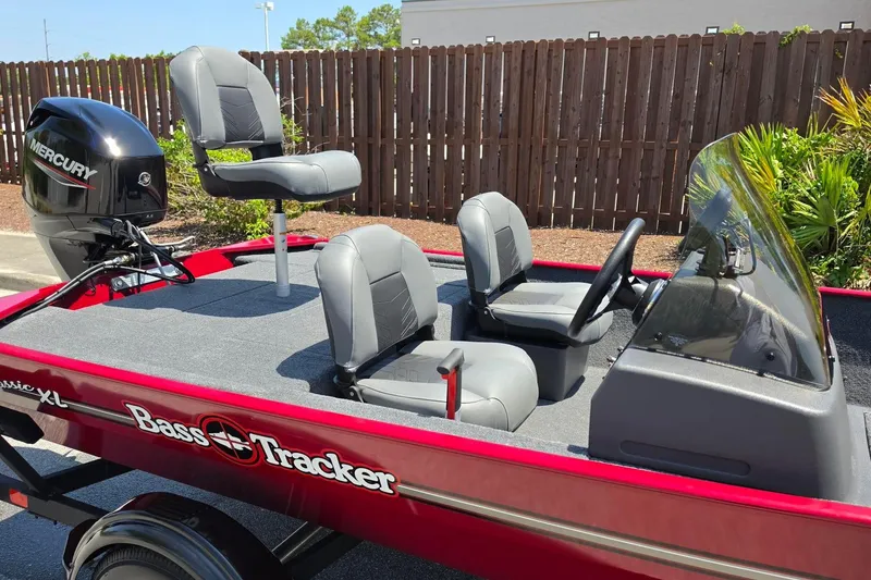 Slide: The Image of 2026 Tracker Bass Tracker Classic XL boat with Mercury engine, featuring comfortable seating and sleek design. - 13
