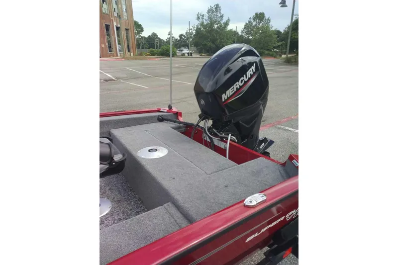 Slide: The Image of 2026 Tracker Super Guide V-16 SC boat with Mercury outboard motor in parking lot. - 6