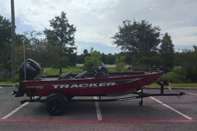 The Image of 2026 Tracker Super Guide V-16 SC boat on trailer in parking lot. - 0
