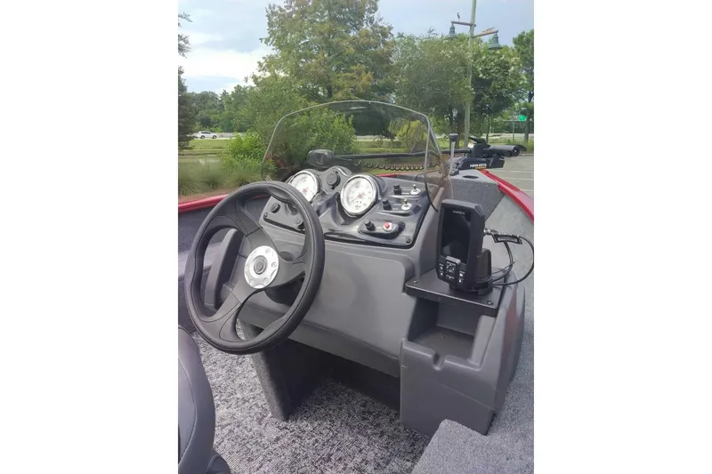 Slide: The Image of 2026 Tracker Super Guide V-16 SC boat dashboard with steering wheel and gauges. - 7
