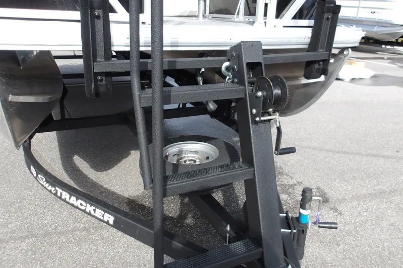 Slide: The Image of 2026 Sun Tracker Fishin' Barge 22 DLX trailer hitch and ladder detail. - 20