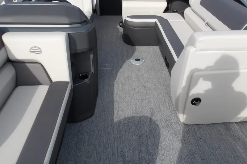 Slide: The Image of 2026 Sun Tracker Fishin' Barge 22 DLX interior with gray and white seating. - 25