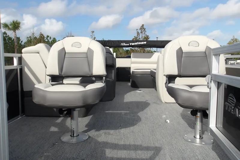 Slide: The Image of 2026 Sun Tracker Fishin' Barge 22 DLX interior with comfortable seating and spacious layout. - 21