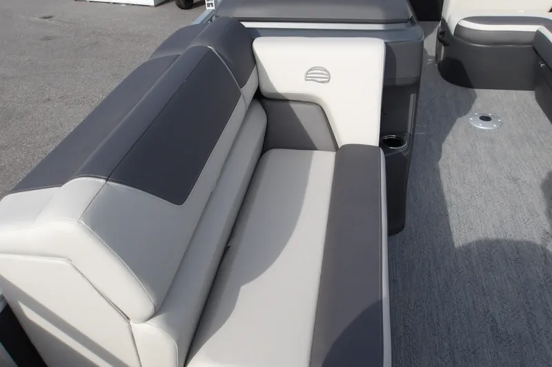 Slide: The Image of 2026 Sun Tracker Fishin' Barge 22 DLX interior seating, featuring gray and white upholstery. - 26