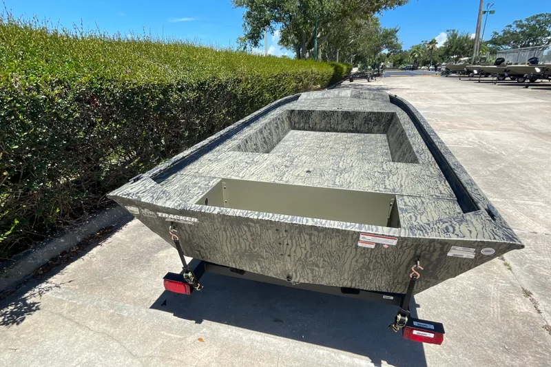 Slide: The Image of 2026 Tracker Grizzly 1754 Utility boat with camouflage design on a sunny day. - 6