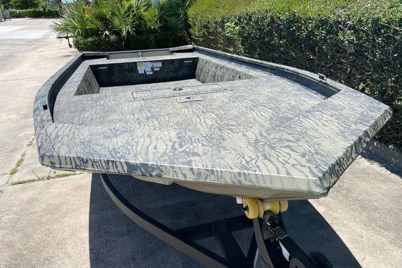 Slide: The Image of 2026 Tracker Grizzly 1754 Utility boat with camouflage pattern on a trailer. - 7