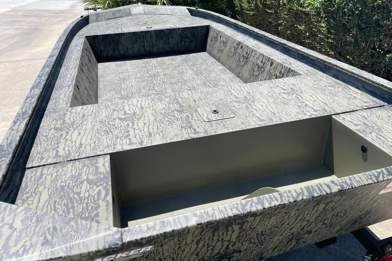 Slide: The Image of 2026 Tracker Grizzly 1754 Utility boat with camouflage design, parked outdoors. - 9