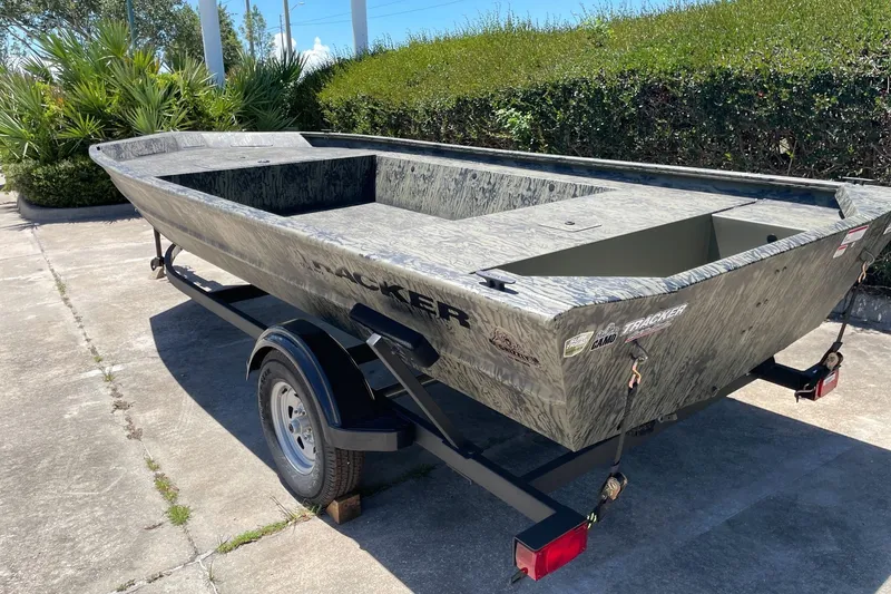 Slide: The Image of 2026 Tracker Grizzly 1754 Utility boat on trailer, parked outdoors. - 4