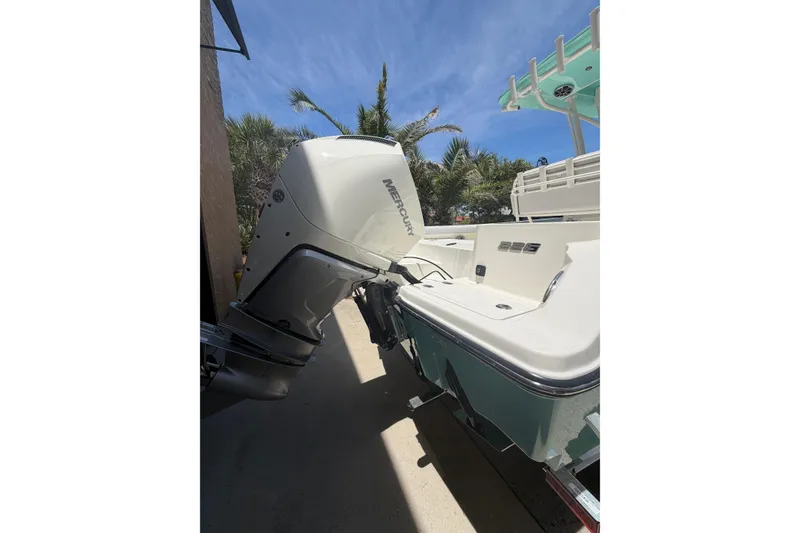 Slide: The Image of 2026 Mako 226 Center Console boat with Mercury outboard engine, parked outdoors. - 10