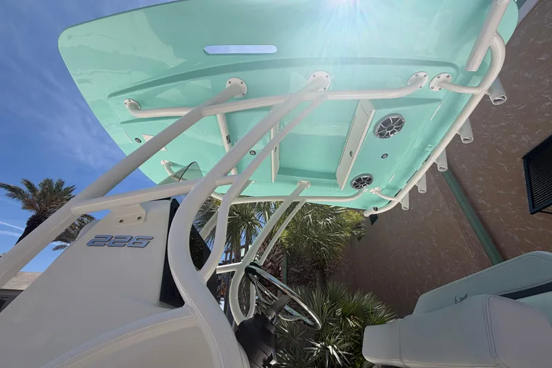 Slide: The Image of 2026 Mako 226 Center Console boat with teal canopy and sleek design. - 4
