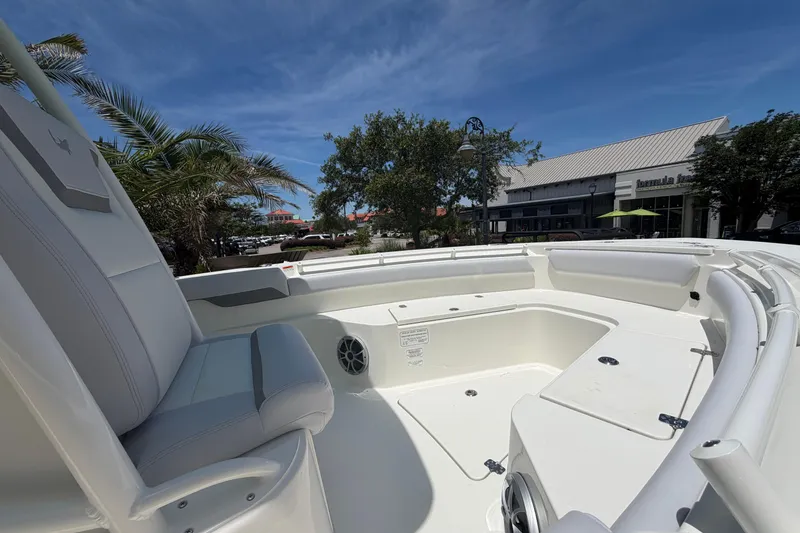 Slide: The Image of 2026 Mako 226 Center Console boat interior with seating and storage, under a clear blue sky. - 9