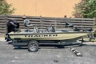 The Image of 2026 Tracker Pro Team 190 fishing boat on trailer, parked outdoors. - 0