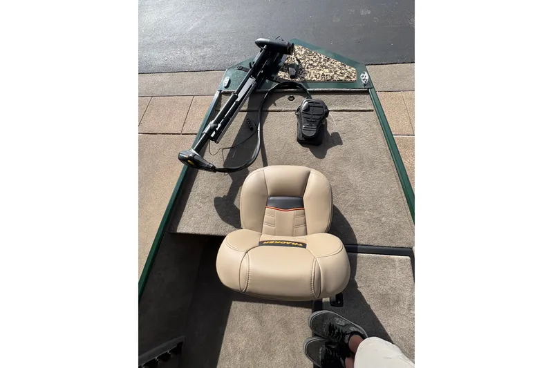 Slide: The Image of 2026 Tracker Bass Tracker Classic Limited boat interior with beige seat and trolling motor. - 7