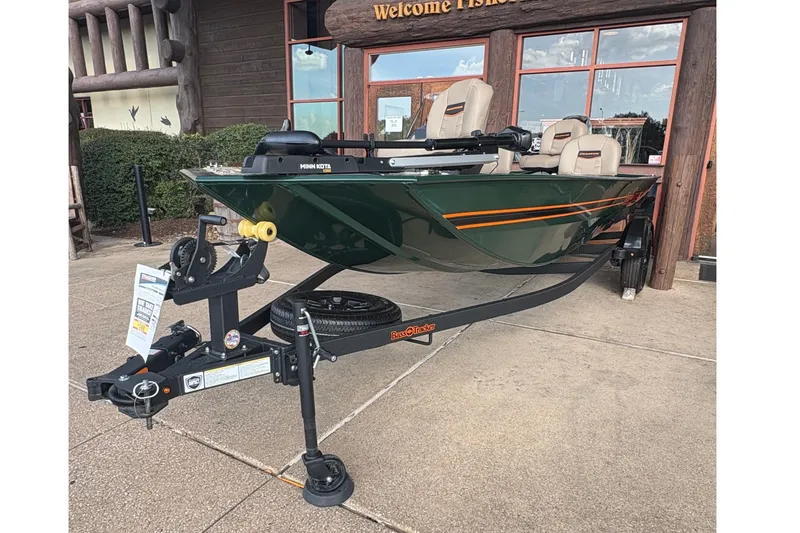 The Image of A green 2026 Bass Tracker Classic Limited boat on a trailer in front of a building. - 0