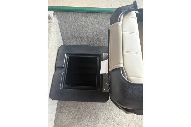 Slide: The Image of A seat with a black storage compartment underneath on a boat. - 14