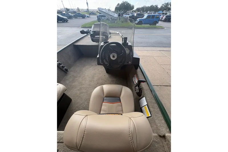 Slide: The Image of Interior view of 2026 Tracker Bass Tracker Classic Limited boat with steering console and seating. - 10