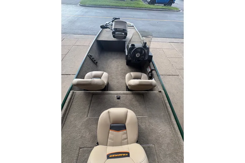 Slide: The Image of 2026 Tracker Bass Tracker Classic Limited boat interior with beige seats and steering console. - 9