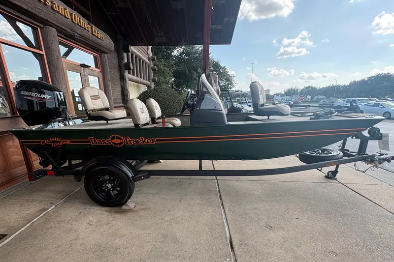 Slide: The Image of A 2026 Tracker Bass Tracker Classic Limited boat on a trailer outside a building. - 5