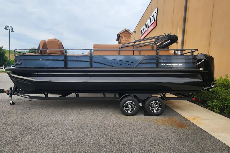 The Image of 2026 Ranger 223FC pontoon boat on trailer, parked outside a Tracker store. - 0