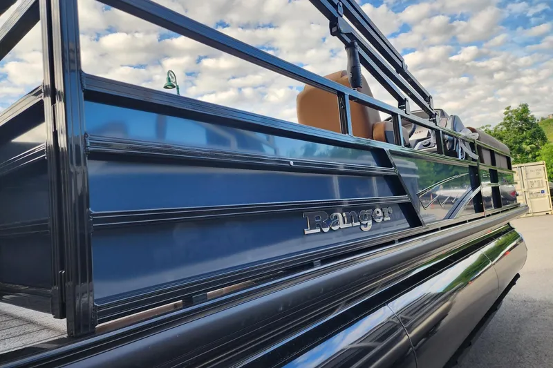 Slide: The Image of 2026 Ranger 223FC boat with sleek design against a cloudy sky backdrop. - 2