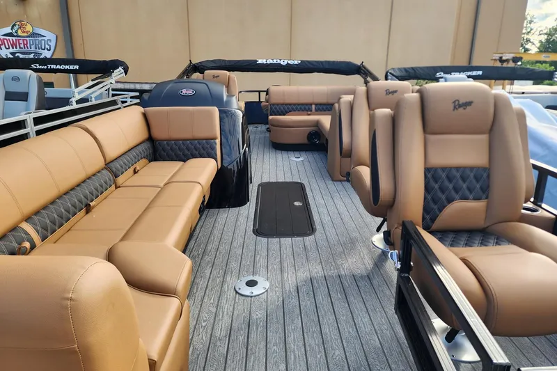 Slide: The Image of 2026 Ranger 223FC boat interior with luxurious tan and black seating, showcasing spacious design. - 4