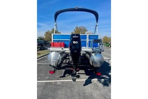 Slide: The Image of 2026 Sun Tracker Party Barge 16 DLX pontoon boat with 50 HP engine in parking lot. - 2