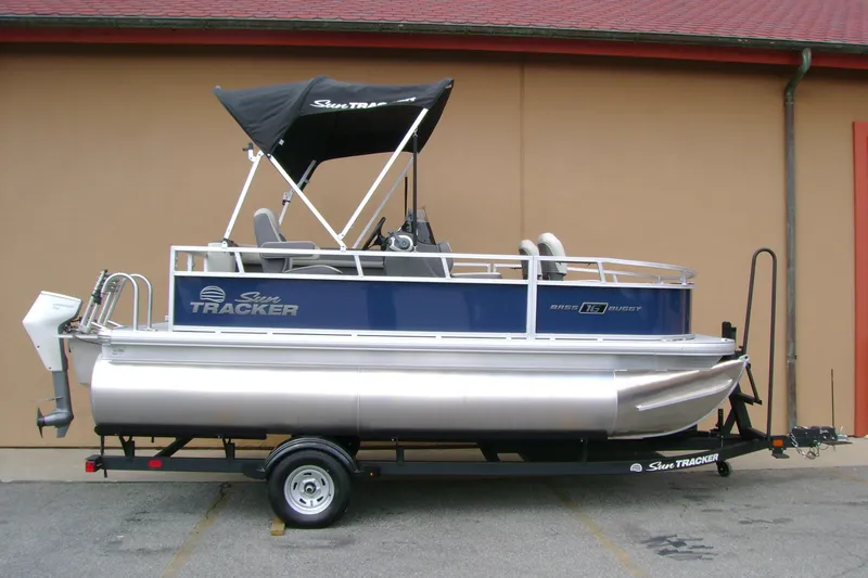 The Image of 2026 Sun Tracker Bass Buggy 16 XL Select pontoon boat on trailer, side view. - 0