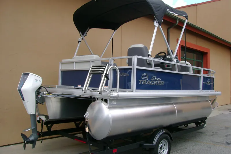 Slide: The Image of 2026 Sun Tracker Bass Buggy 16 XL Select pontoon boat with Mercury outboard motor. - 2