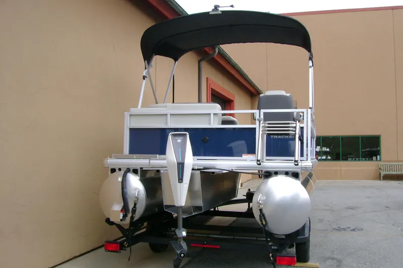 Slide: The Image of 2026 Sun Tracker Bass Buggy 16 XL Select pontoon boat on trailer, rear view. - 4