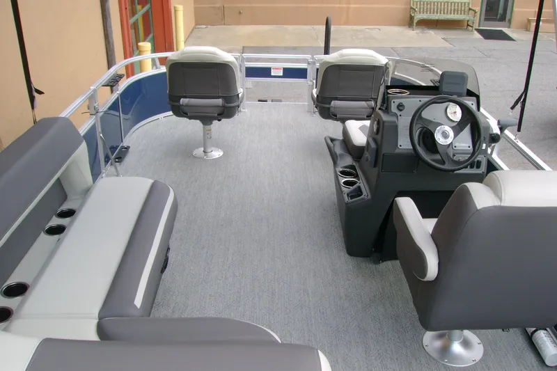 Slide: The Image of 2026 Sun Tracker Bass Buggy 16 XL Select pontoon boat interior with seating and steering console. - 6