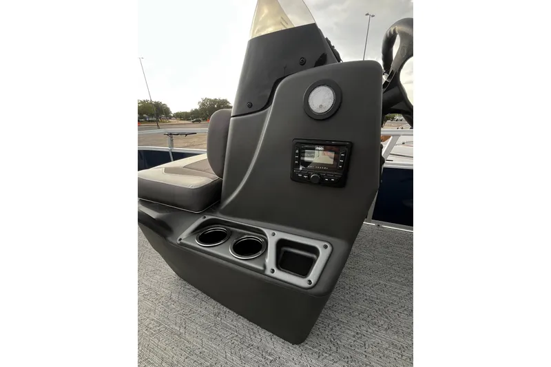 Slide: The Image of 2026 Sun Tracker Bass Buggy 16 XL Select console with cup holders and audio controls. - 18