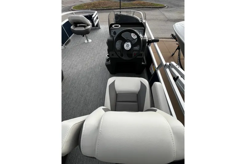 Slide: The Image of Interior view of 2026 Sun Tracker Bass Buggy 16 XL Select pontoon boat with steering console. - 17