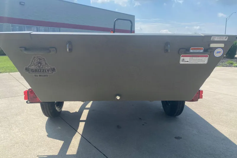 Slide: The Image of 2026 Tracker Grizzly 14 Jon boat rear view, showcasing all-welded construction on pavement. - 4