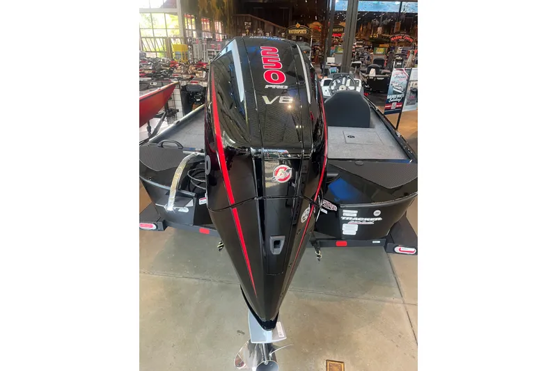 Slide: The Image of 2026 Tracker Savage 215 boat with powerful V8 engine displayed indoors. - 2