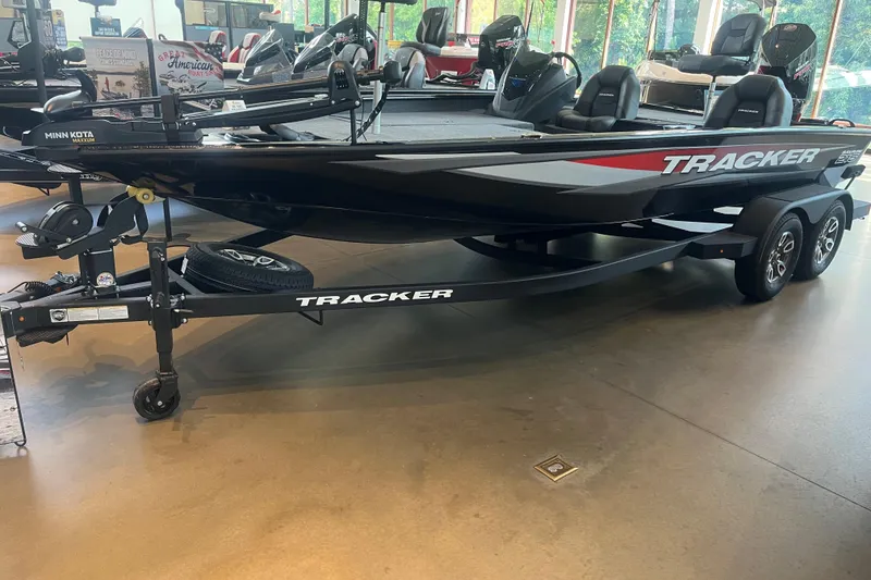 The Image of 2026 Tracker Savage 215 boat on display in showroom with trailer. - 0