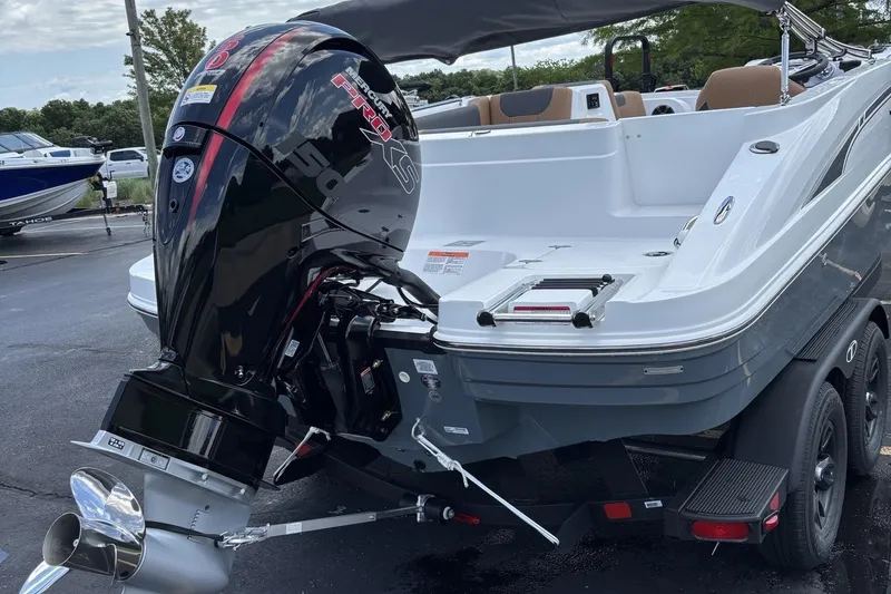 Slide: The Image of 2026 Tahoe 1950 boat with powerful outboard motor, parked on a trailer. - 3