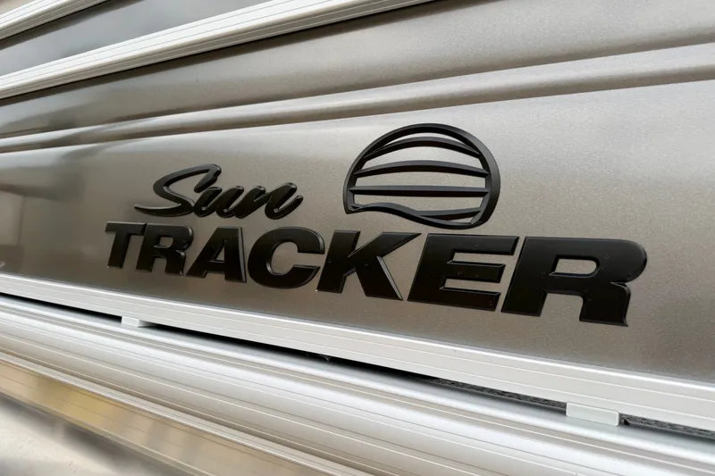 Slide: The Image of 2026 Sun Tracker Fishin' Barge 22 XP3 logo on metallic surface. - 12