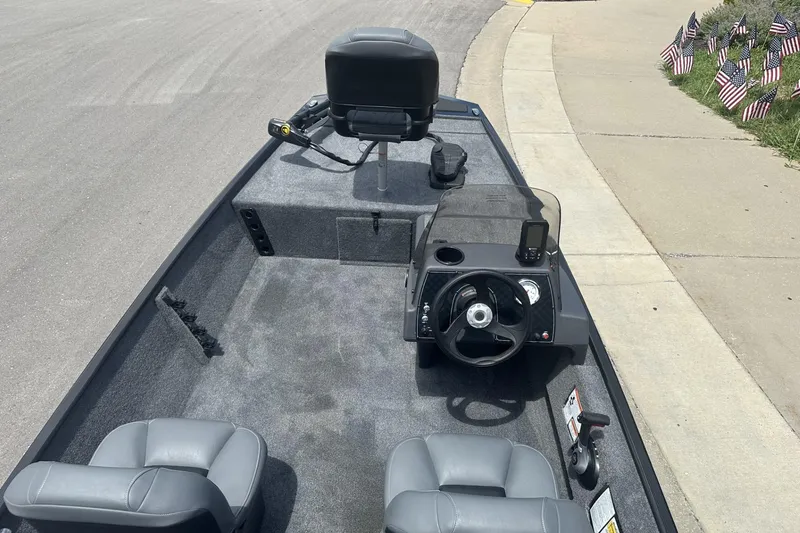 Slide: The Image of 2026 Tracker Bass Tracker Classic XL boat interior with steering wheel and seating. - 10