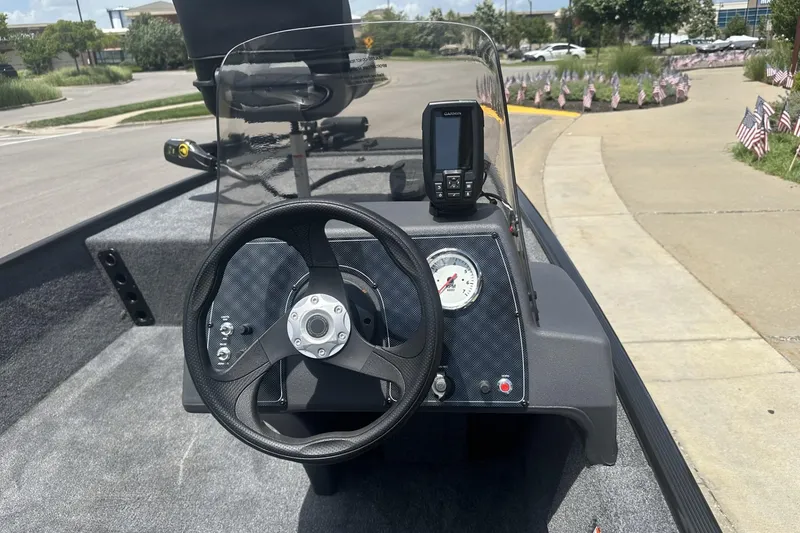 Slide: The Image of 2026 Tracker Bass Tracker Classic XL boat dashboard with steering wheel and navigation system. - 9