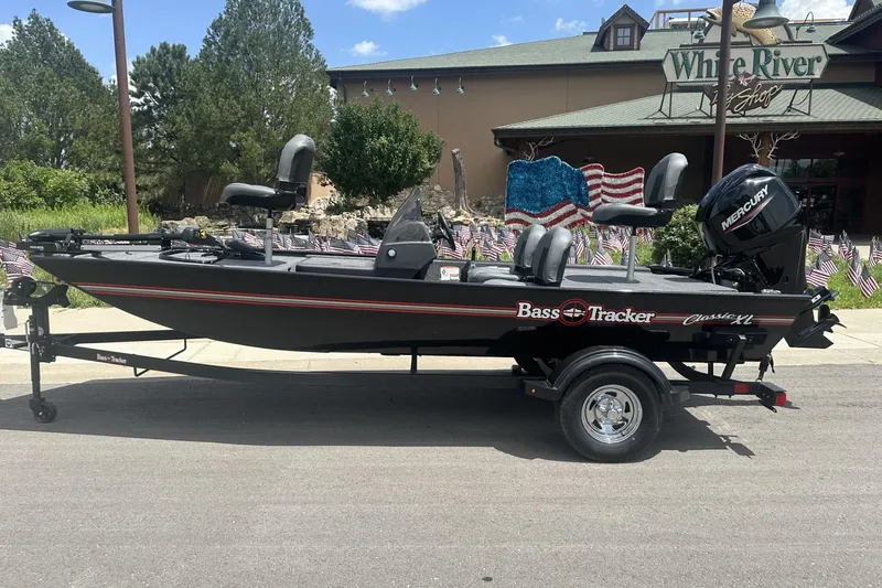 The Image of 2026 Tracker Bass Tracker Classic XL boat on trailer, parked outdoors. - 0