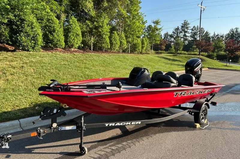 Slide: The Image of 2026 Tracker Pro Team 175 Crappie Edition boat on trailer, parked outdoors. - 2