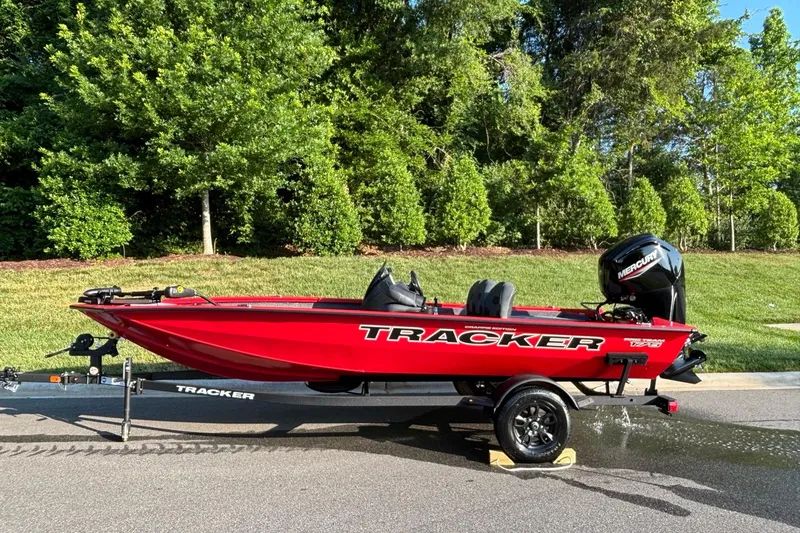 The Image of 2026 Tracker Pro Team 175 Crappie Edition boat on trailer, vibrant red, parked outdoors. - 0