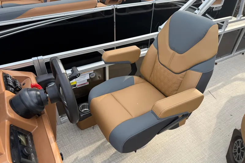 Slide: The Image of Captain's chair on 2026 Tahoe Pontoon Sport 85 Rear Fish boat, featuring tan and gray upholstery. - 8