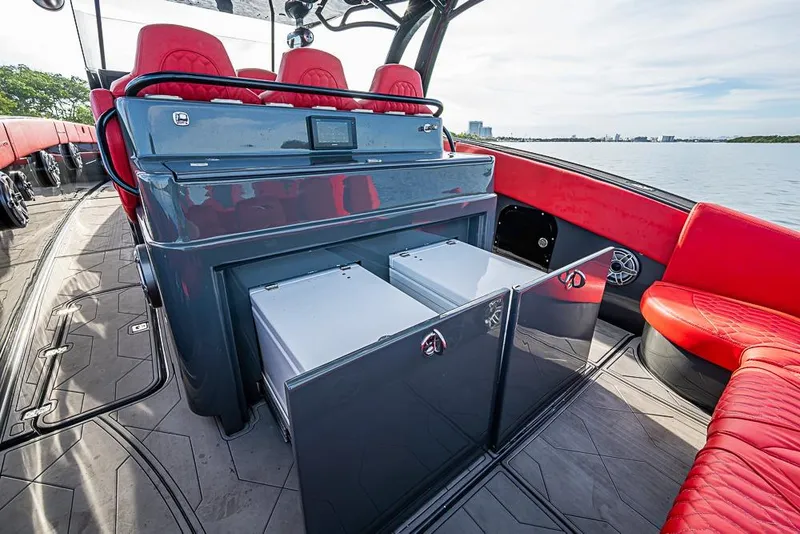 Slide: The Image of Luxury interior of 2021 Midnight Express 43 Solstice boat with red seating and storage compartments. - 12