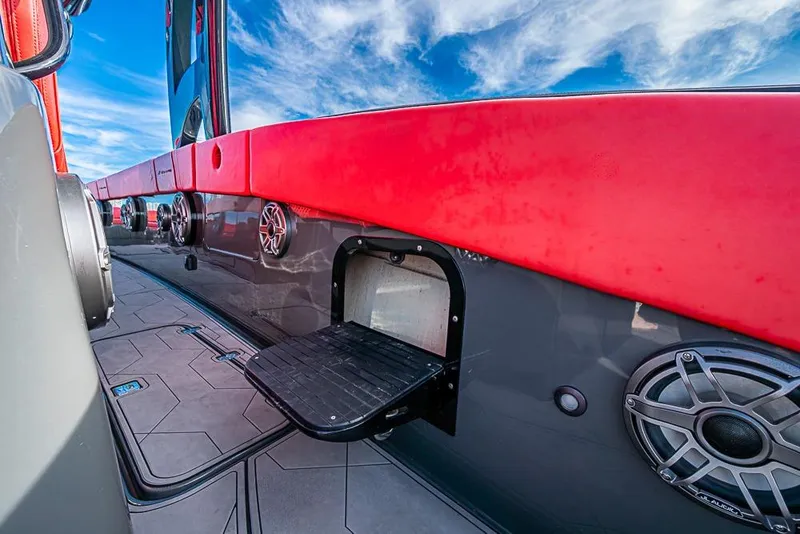 Slide: The Image of 2021 Midnight Express 43 Solstice boat with red and gray detailing, outdoor speakers, and step. - 14