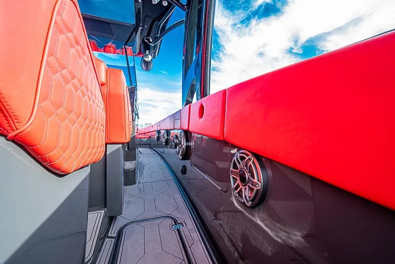 Slide: The Image of Interior view of 2021 Midnight Express 43 Solstice boat with red seating and speaker detail. - 15